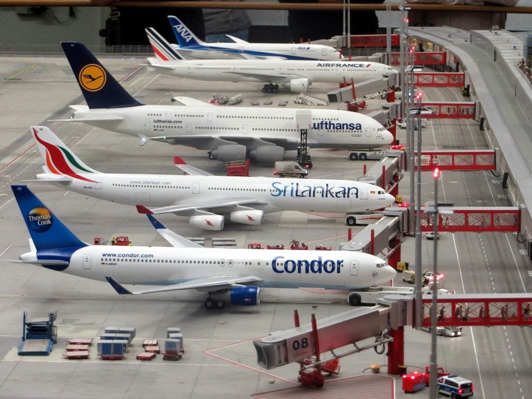 aeroplanes parked up at an airport in a row