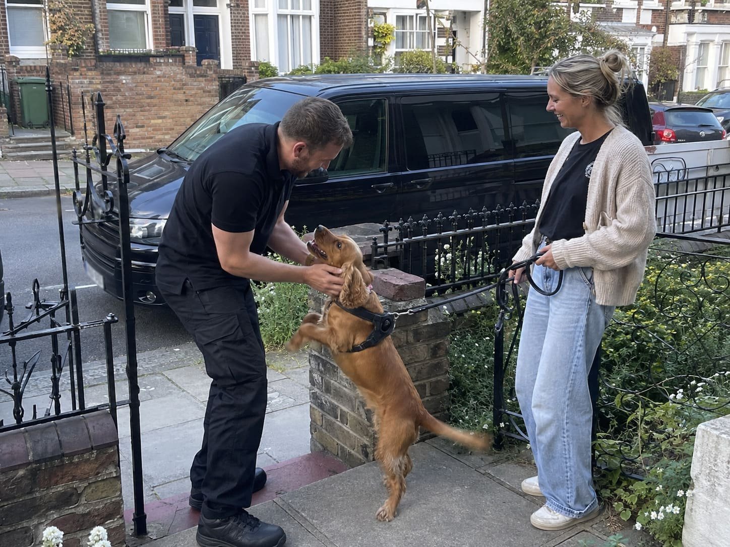 London pet transport professional greeting an excited dog before collection